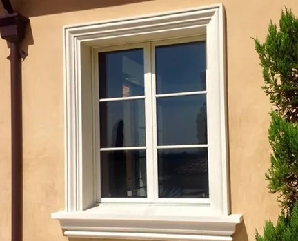 Window with a stone-effect frame on a warm wall