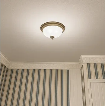 Ceiling light with striped wallpaper and a cornice